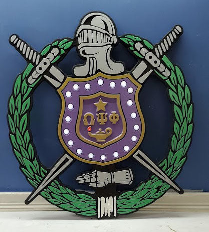 alt= "Omega Psi Phi Fraternity - Carved Retro Shield. It is provided with LED lighted pearls and flame. It comes in four sizes (16", 24" 36" and 48" high."
